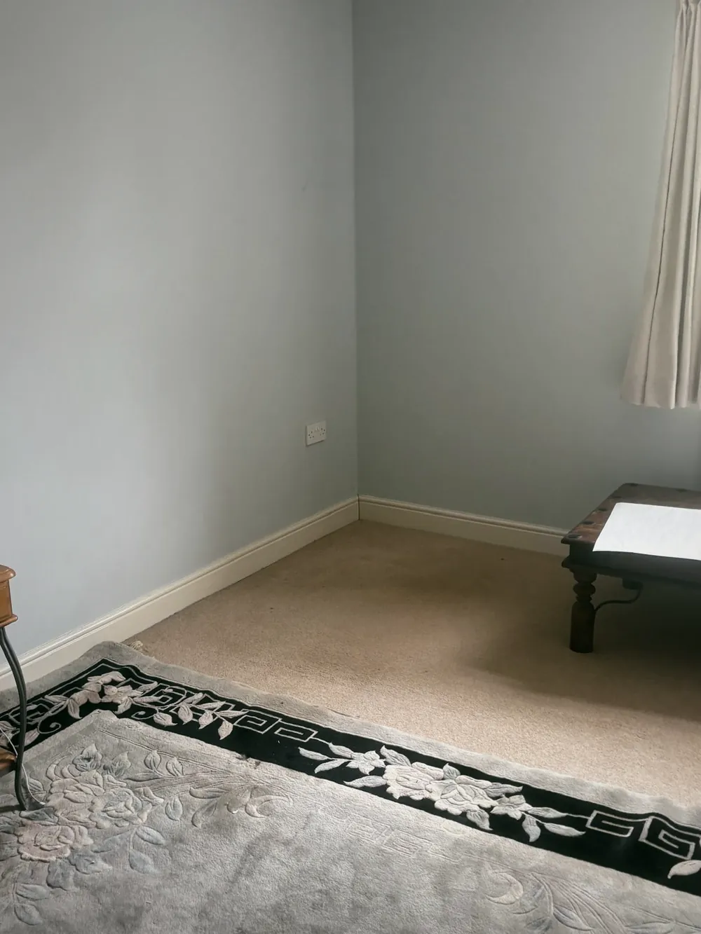After: Room emptied, rug and curtain the only things left.