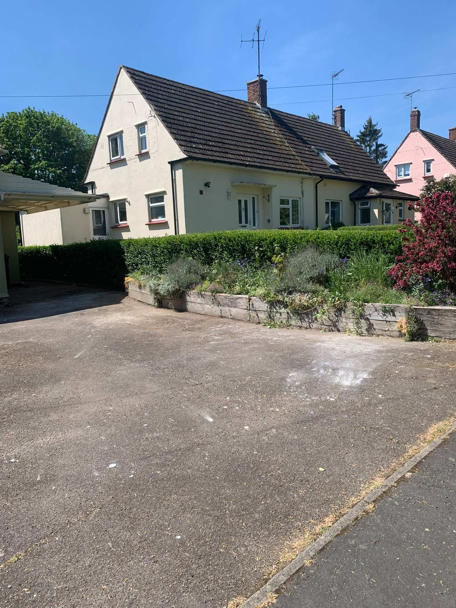 A wide driveway and hardstanding cleared and swept in front of a rendered semi