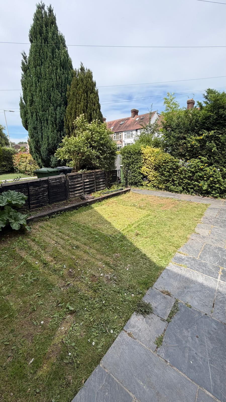 After. Timber gone, path and lawn clear again.