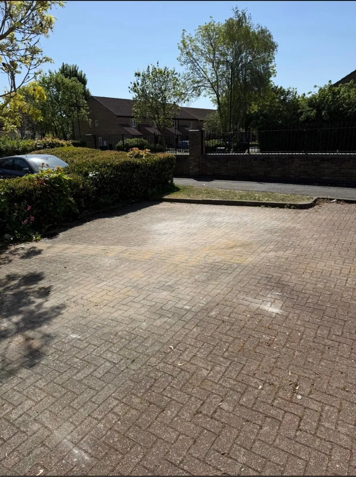 After. Block paving swept back to the surface, the whole bay usable again.