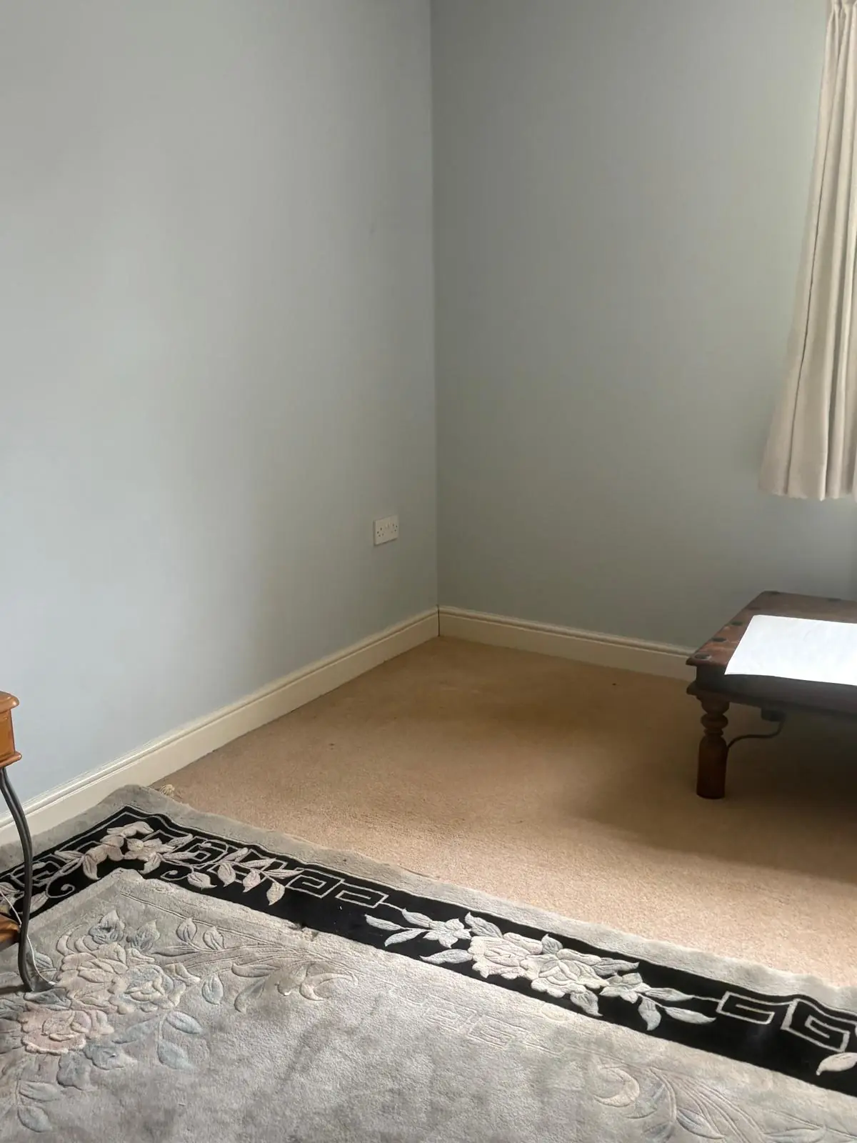 After. Room emptied, rug and curtain the only things left.