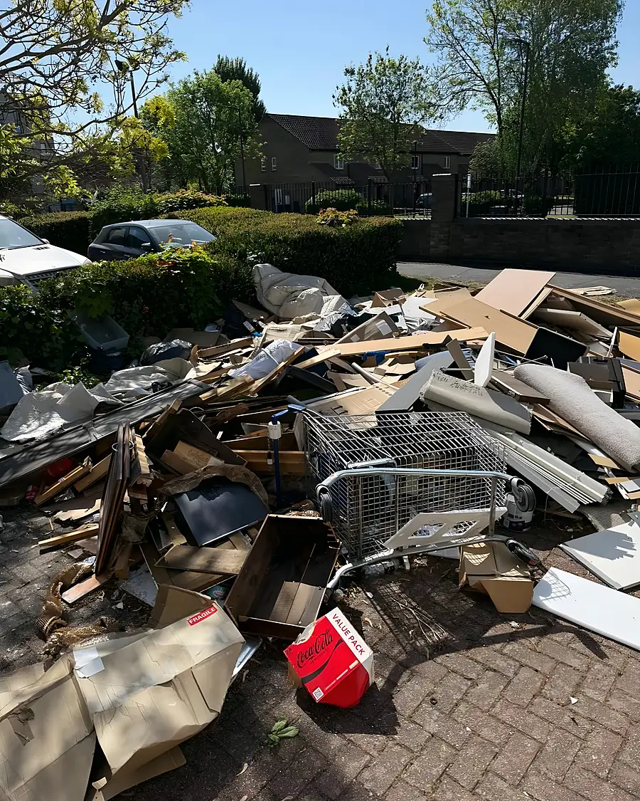 Before: Broken furniture, cardboard, a wire trolley and a red fuel can dumped across a residential parking bay
