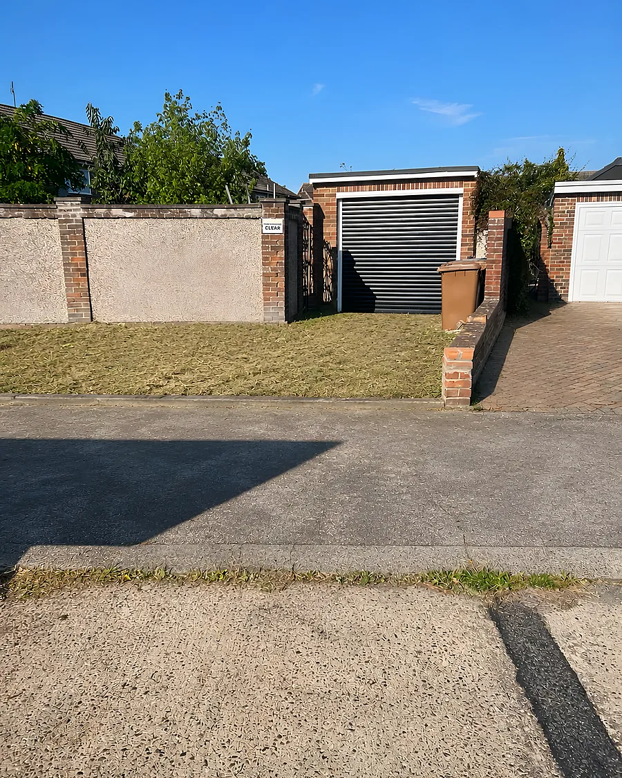 A driveway swept clean in front of an up-and-over garage door