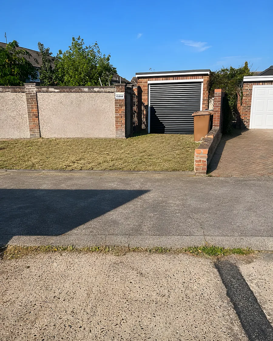 A driveway swept clean in front of an up-and-over garage door
