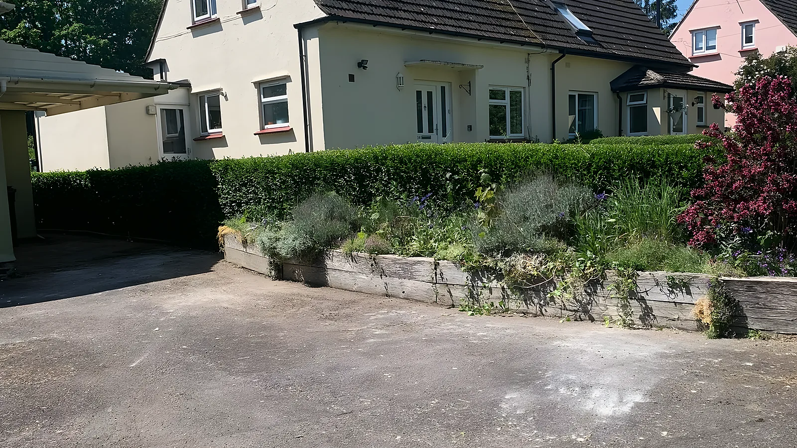 A semi detached house with its front drive cleared and swept