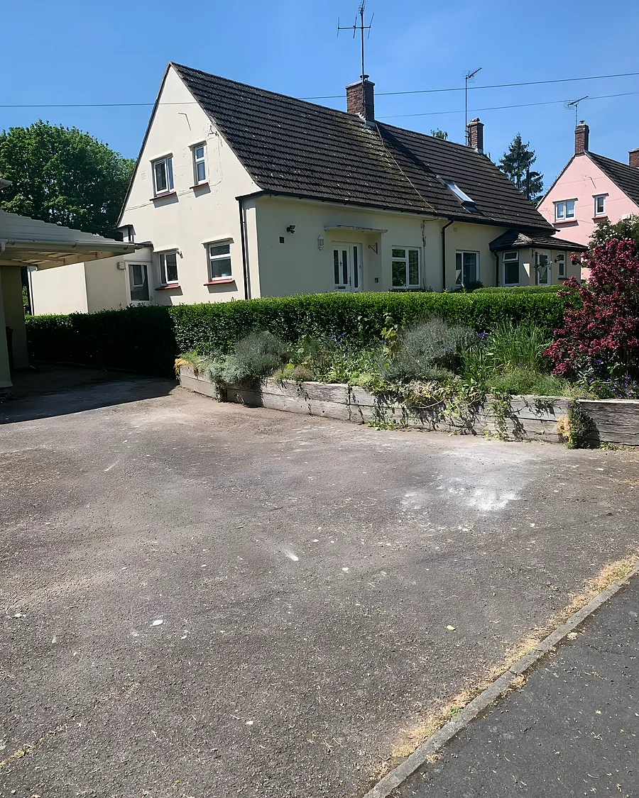 A semi detached house with its front drive cleared and swept