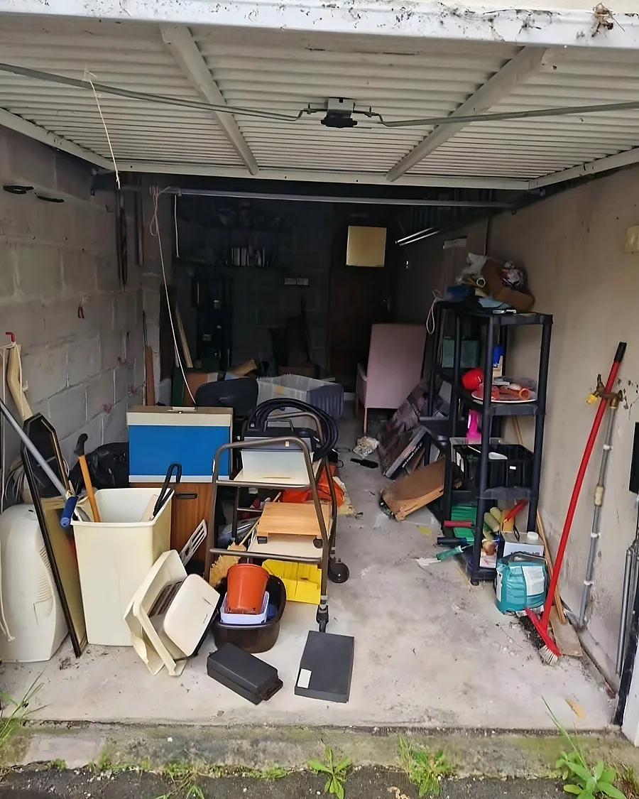 Before: Tools, timber, boxes and a mower filling the garage front to back.