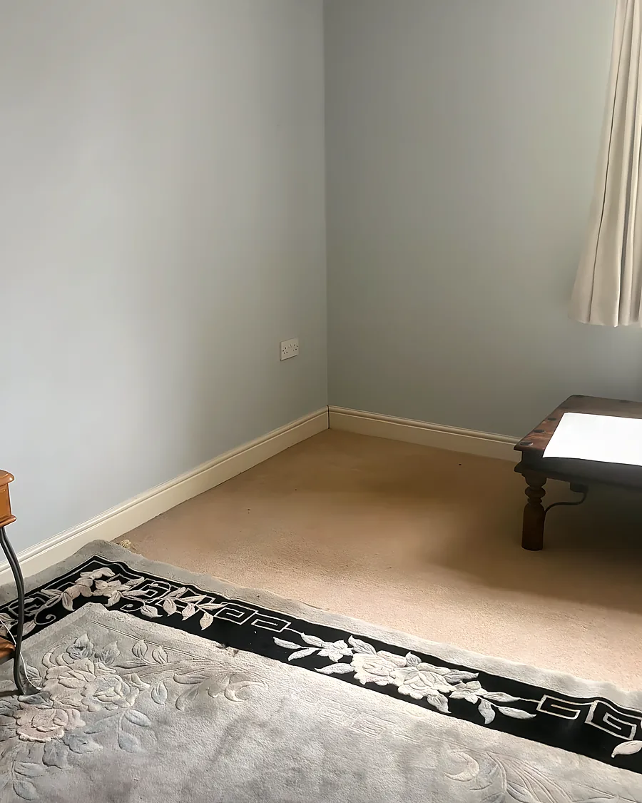 After: Room emptied, rug and curtain the only things left.