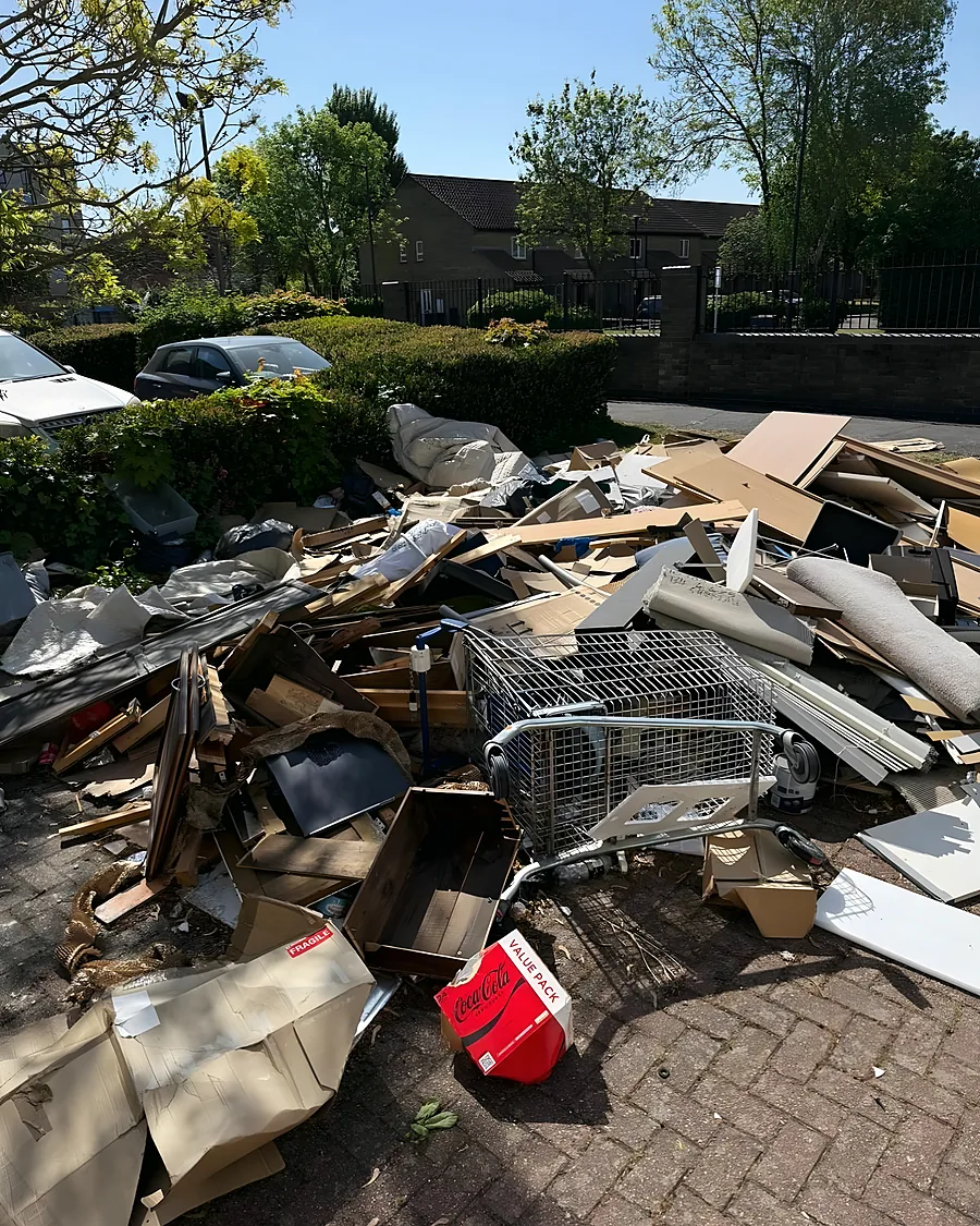 Before: Broken furniture, cardboard, a wire trolley and a fuel can dumped across the parking bay.