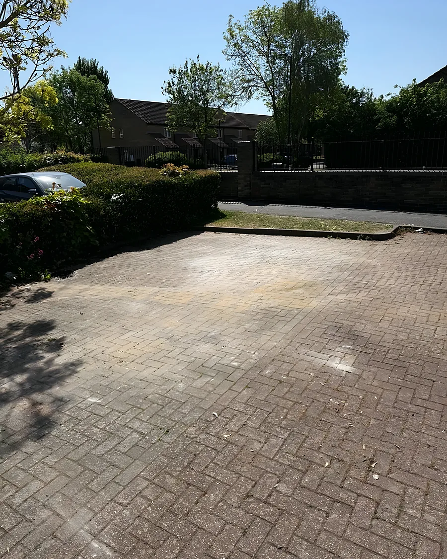 After: Block paving swept back to the surface, the whole bay usable again.